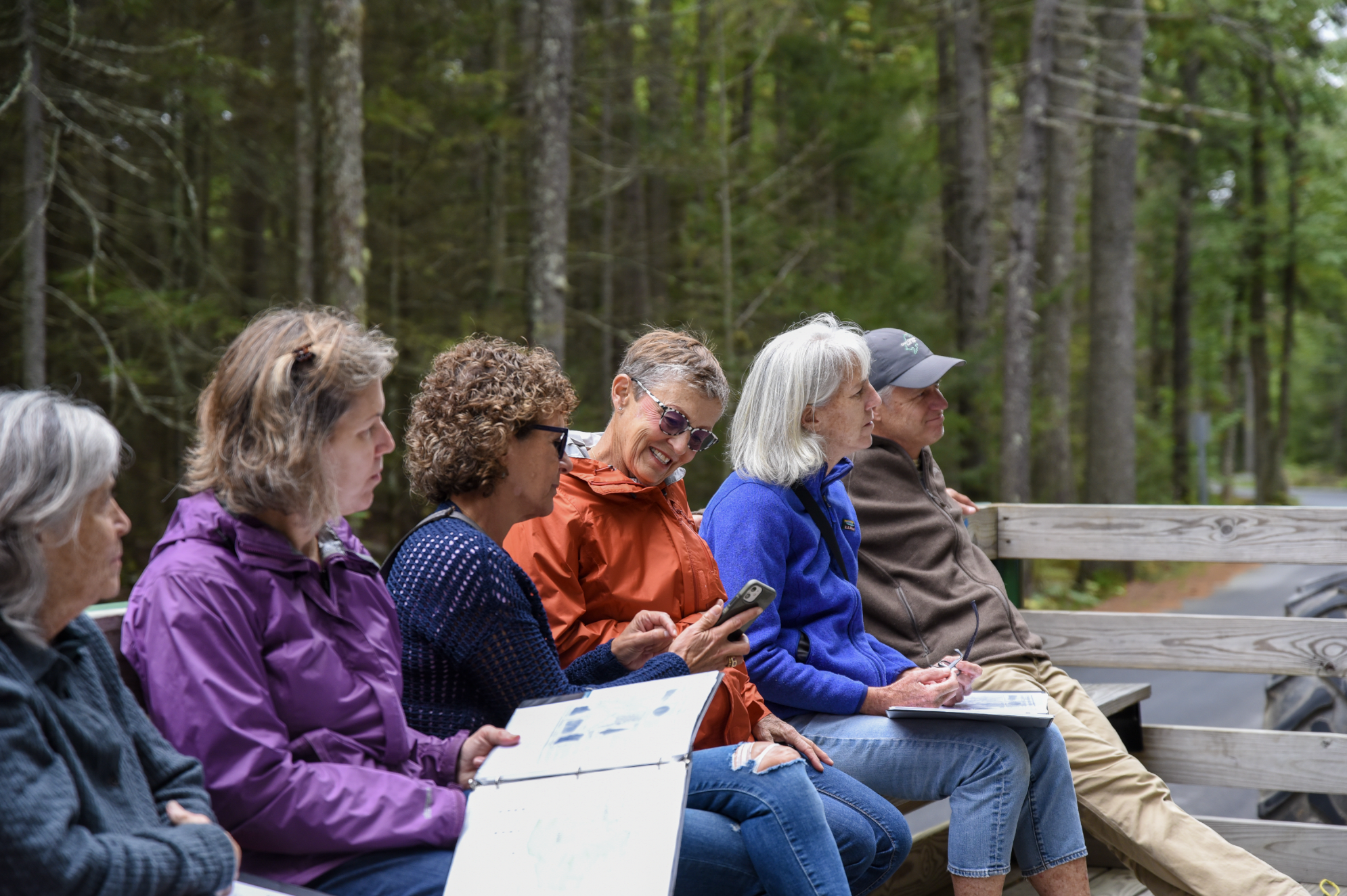 A group of people on a hay ride farm tour